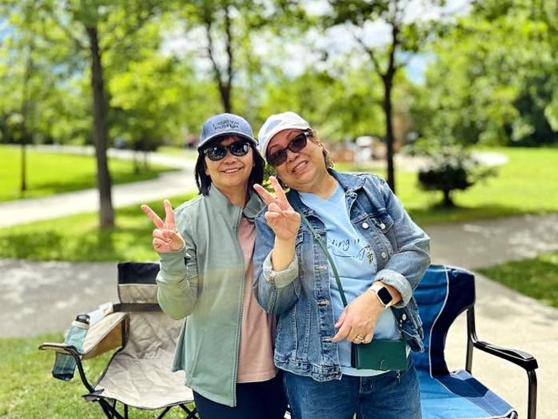 Two church members smiling at a summer picnic